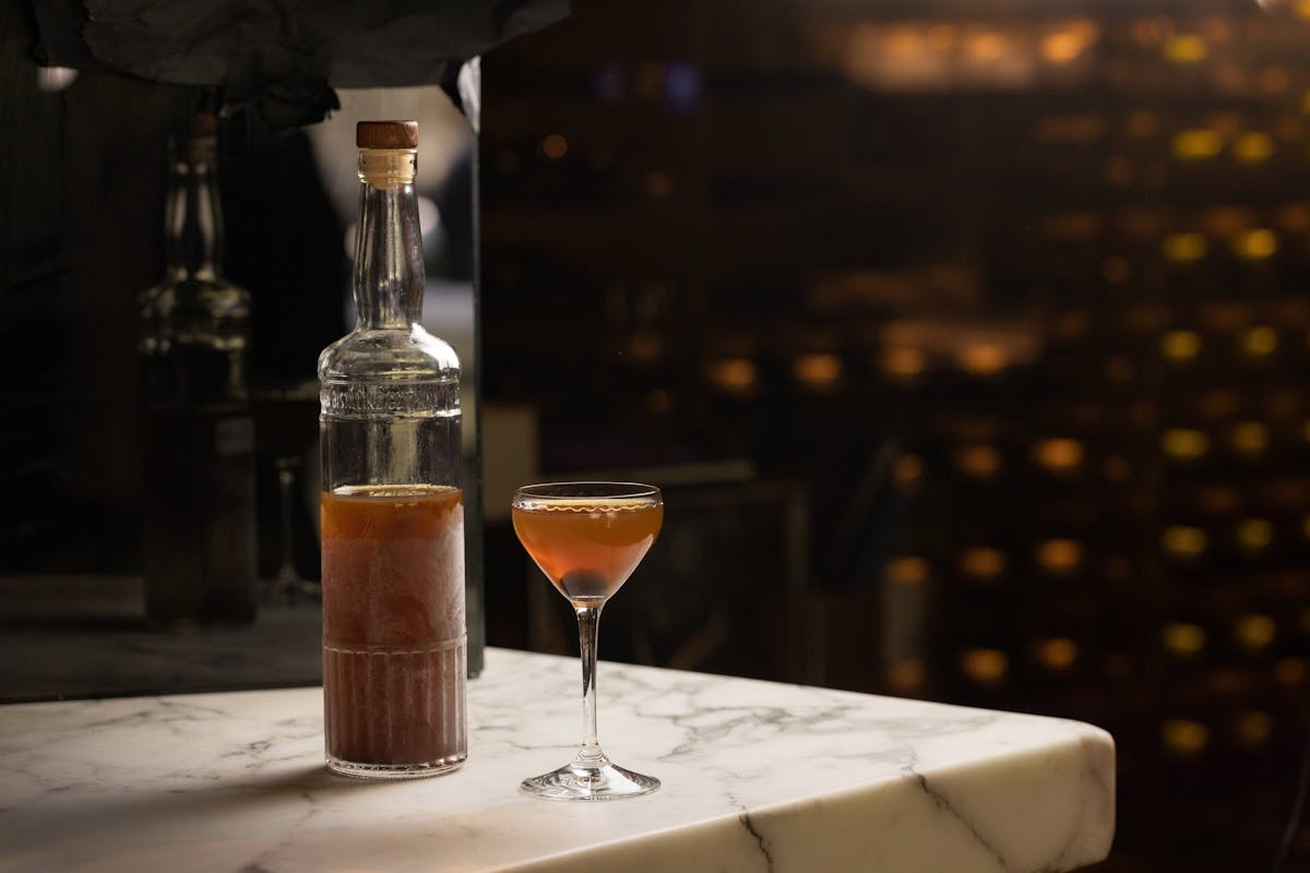 a glass of wine sitting on top of a table