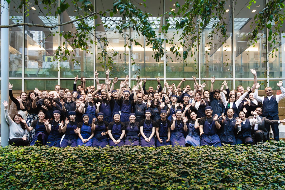 a group of people posing for a photo in front of a crowd